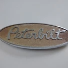 Vintage Peterbilt Hood Emblem, Silver, 8"X3.5", 11 Oz., Lot. Fixed Price $40.00.
